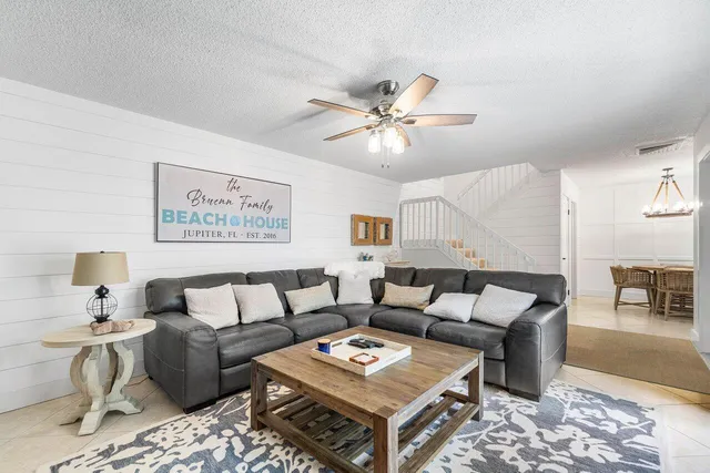 a living room with furniture a rug and a window