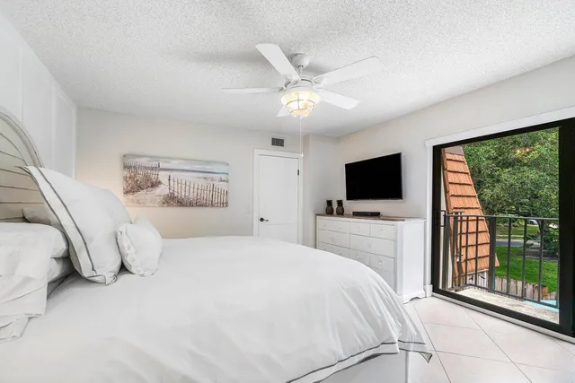 a bedroom with a large bed and flat tv