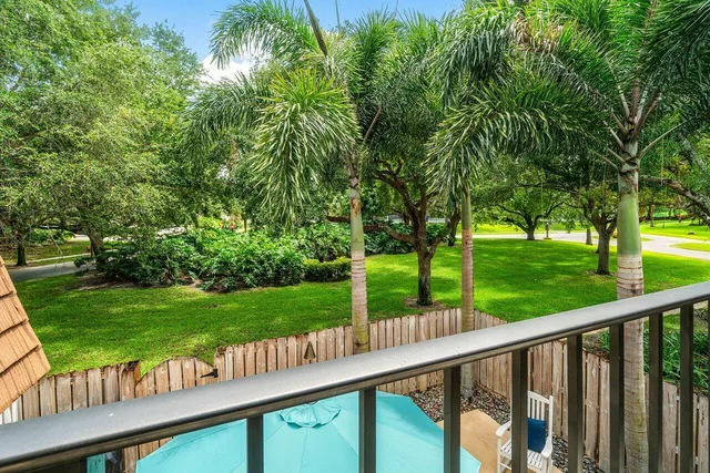 a view of a wooden deck and a yard