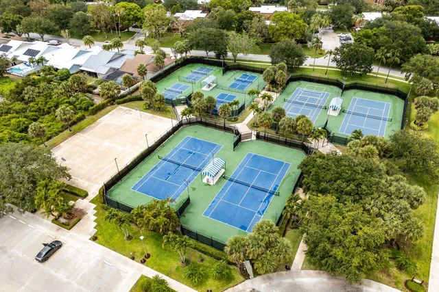 an aerial view of a house with a garden and trees