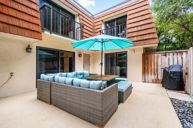 a outdoor space with patio the couches and a fireplace