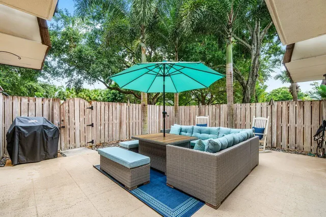 a backyard of a house with table and chairs