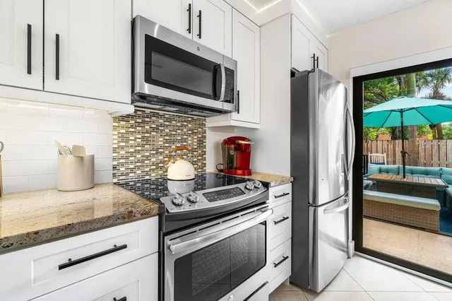 a kitchen with granite countertop stainless steel appliances and cabinets