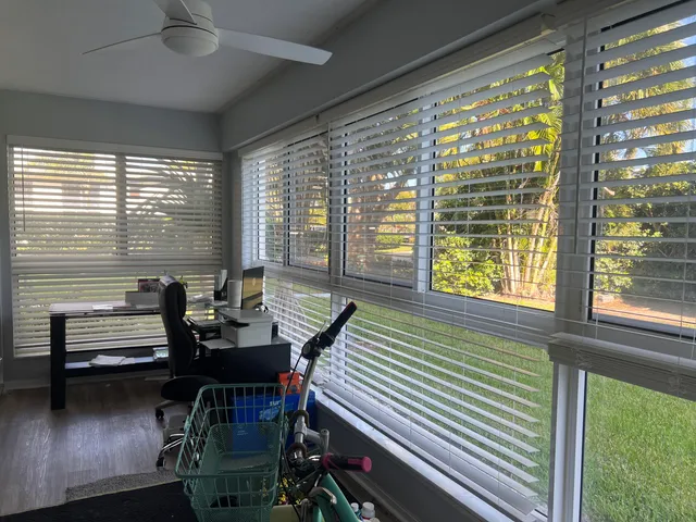 a view of a room with gym equipment and a large window