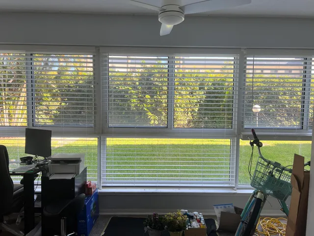 a kitchen with stainless steel appliances granite countertop a stove top oven a sink a refrigerator white cabinets and wooden floor