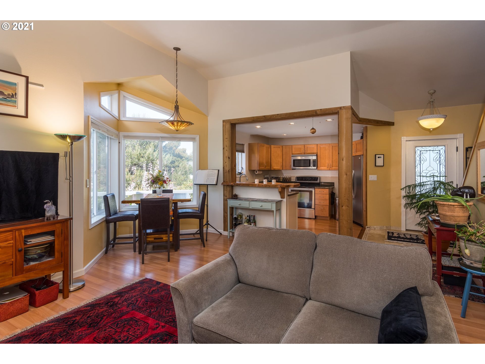 3661 Natalie Way Bandon, OR 97411 - Photo 12 of 32 a living room with furniture a flat screen tv and a kitchen view