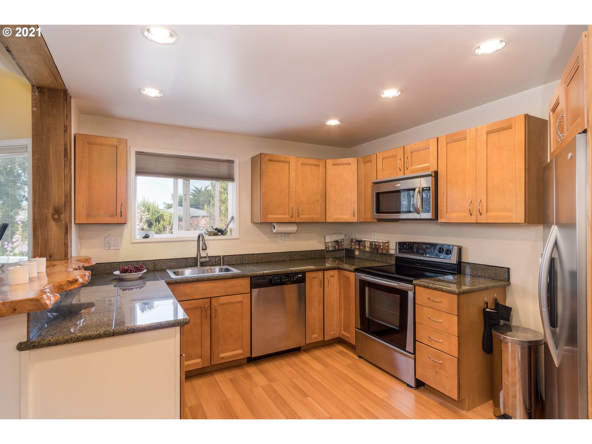 3661 Natalie Way Bandon, OR 97411 - Photo 14 of 32 a kitchen with stainless steel appliances granite countertop sink stove top oven and cabinets