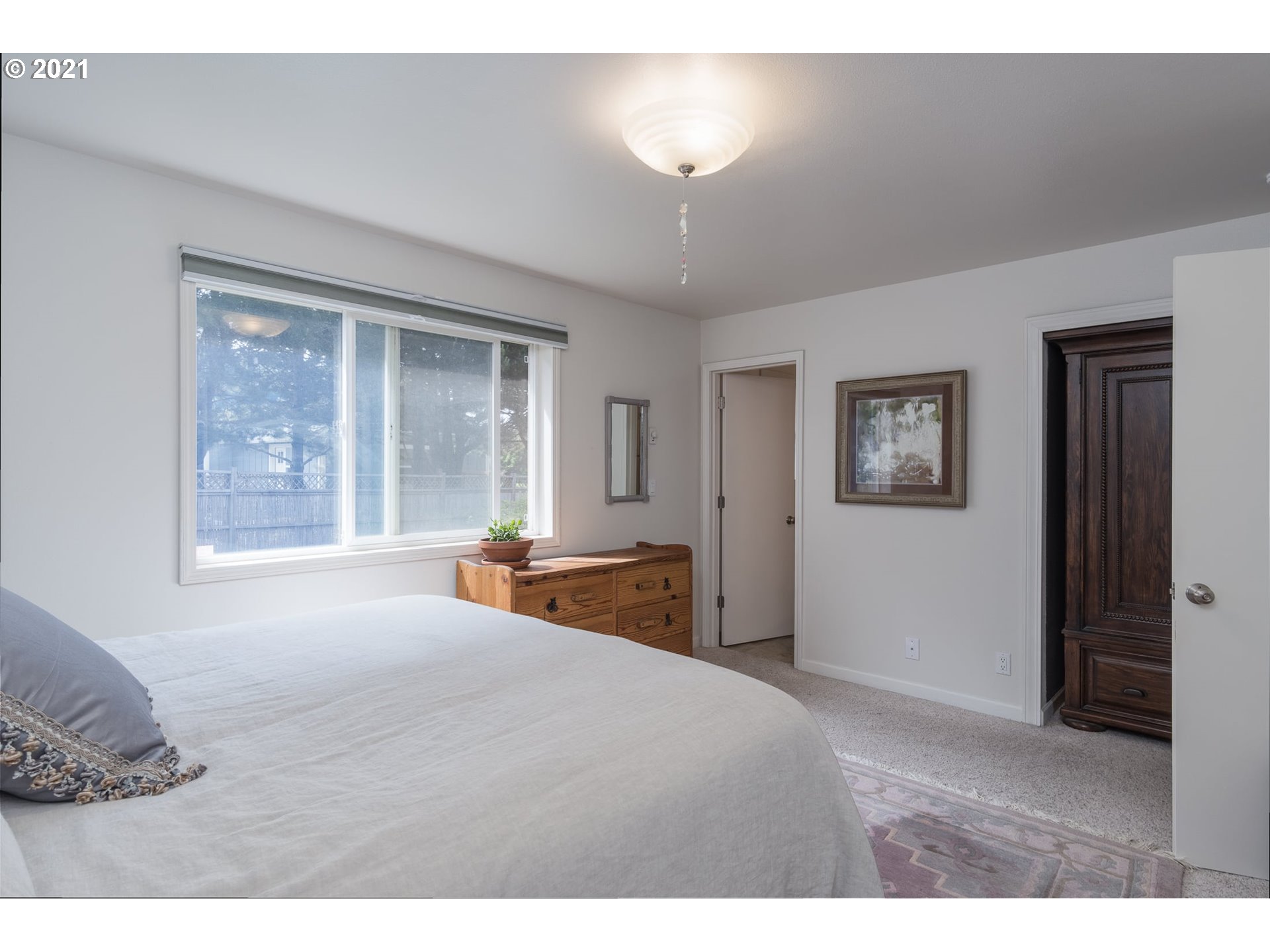 3661 Natalie Way Bandon, OR 97411 - Photo 23 of 32 a bedroom with a large bed and a window
