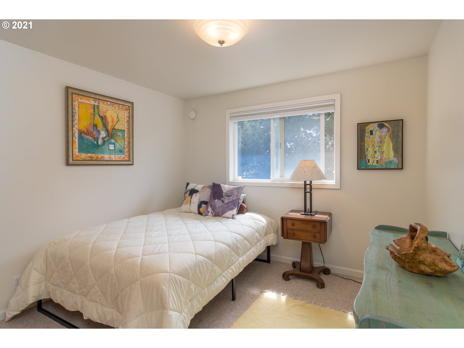 3661 Natalie Way Bandon, OR 97411 - Photo 26 of 32 a bedroom with a bed and a painting on the wall