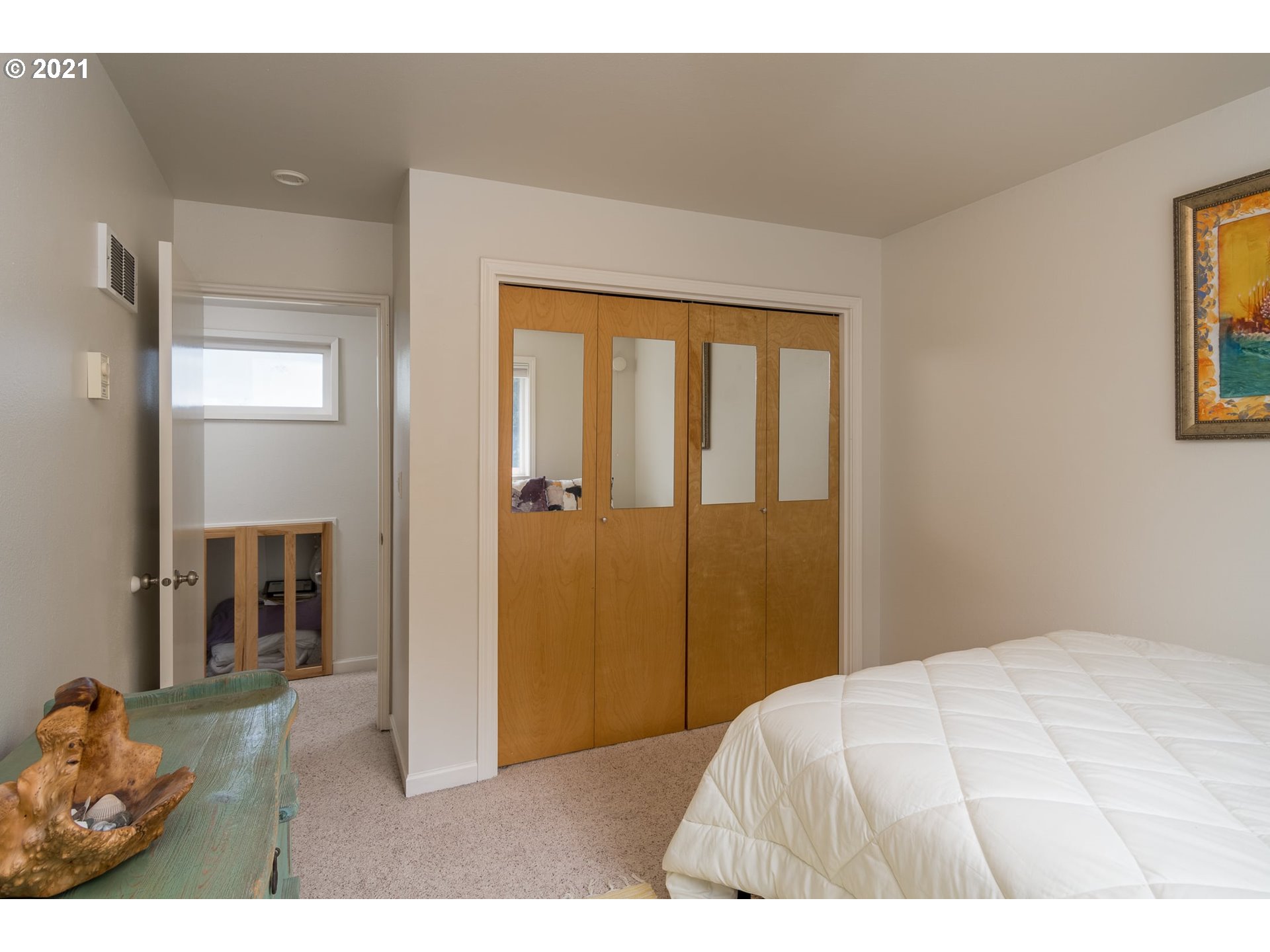 3661 Natalie Way Bandon, OR 97411 - Photo 27 of 32 a bedroom with a bed and a painting on the wall
