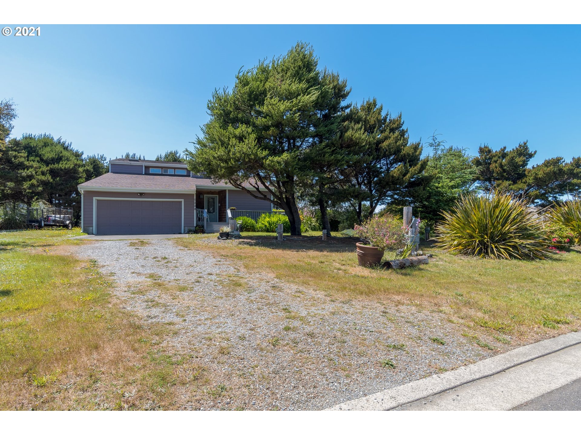 3661 Natalie Way Bandon, OR 97411 - Photo 32 of 32 a view of a yard with a house in the background