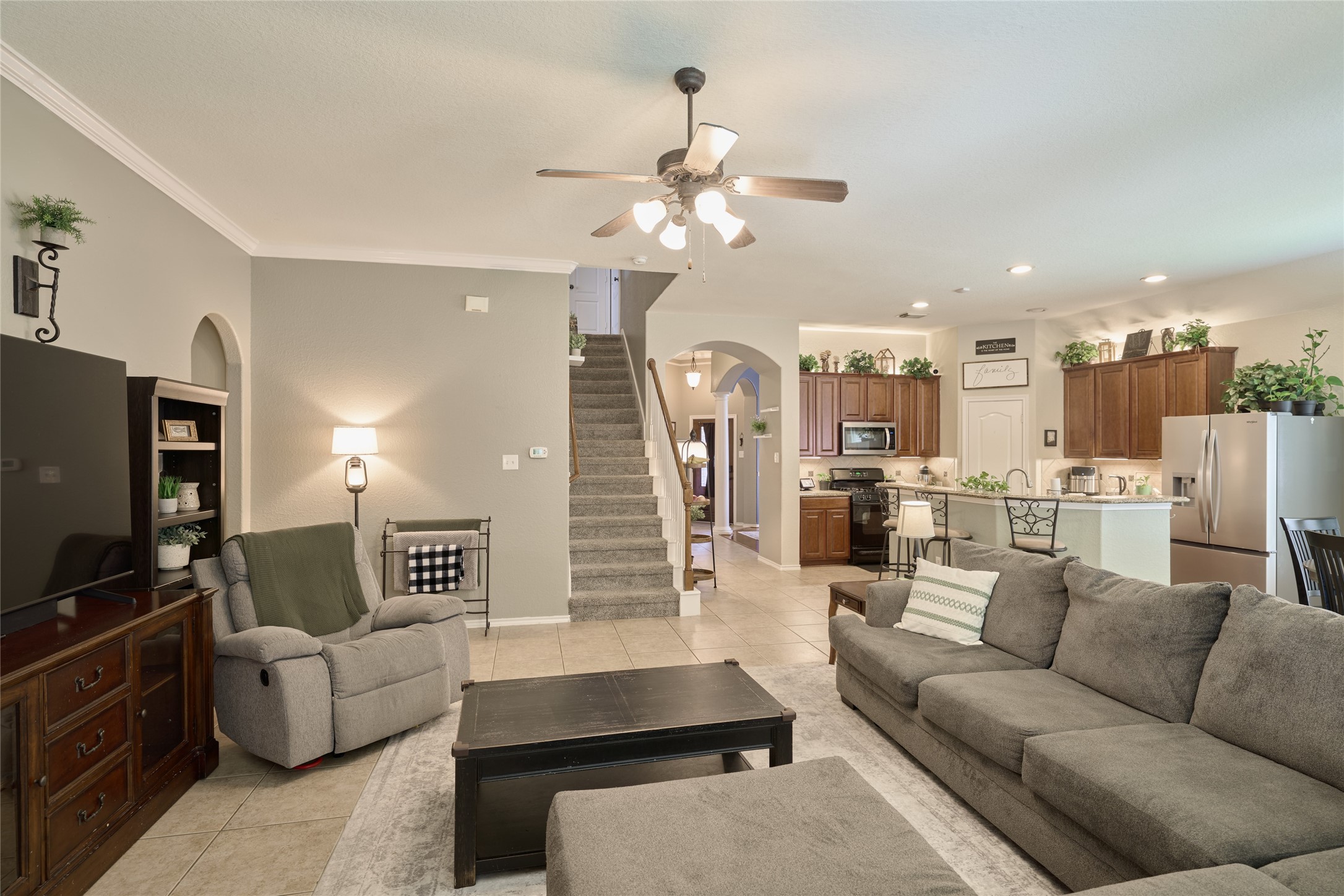 28322 Madelin Manor Lane Spring, TX 77386 - Photo 13 of 46 a living room with furniture kitchen view and a chandelier