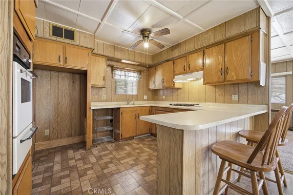 a kitchen with a stove a sink dishwasher and a refrigerator
