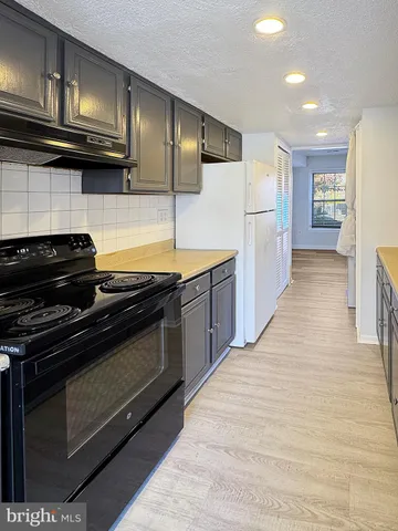 a kitchen with stainless steel appliances granite countertop a stove and a refrigerator