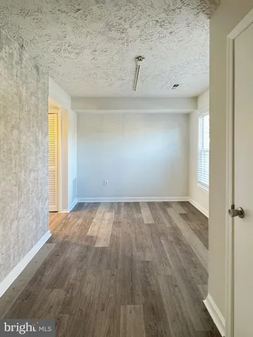 a view of a room with wooden floor and a sink