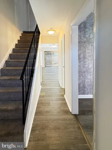 a view of entryway and hall with wooden floor