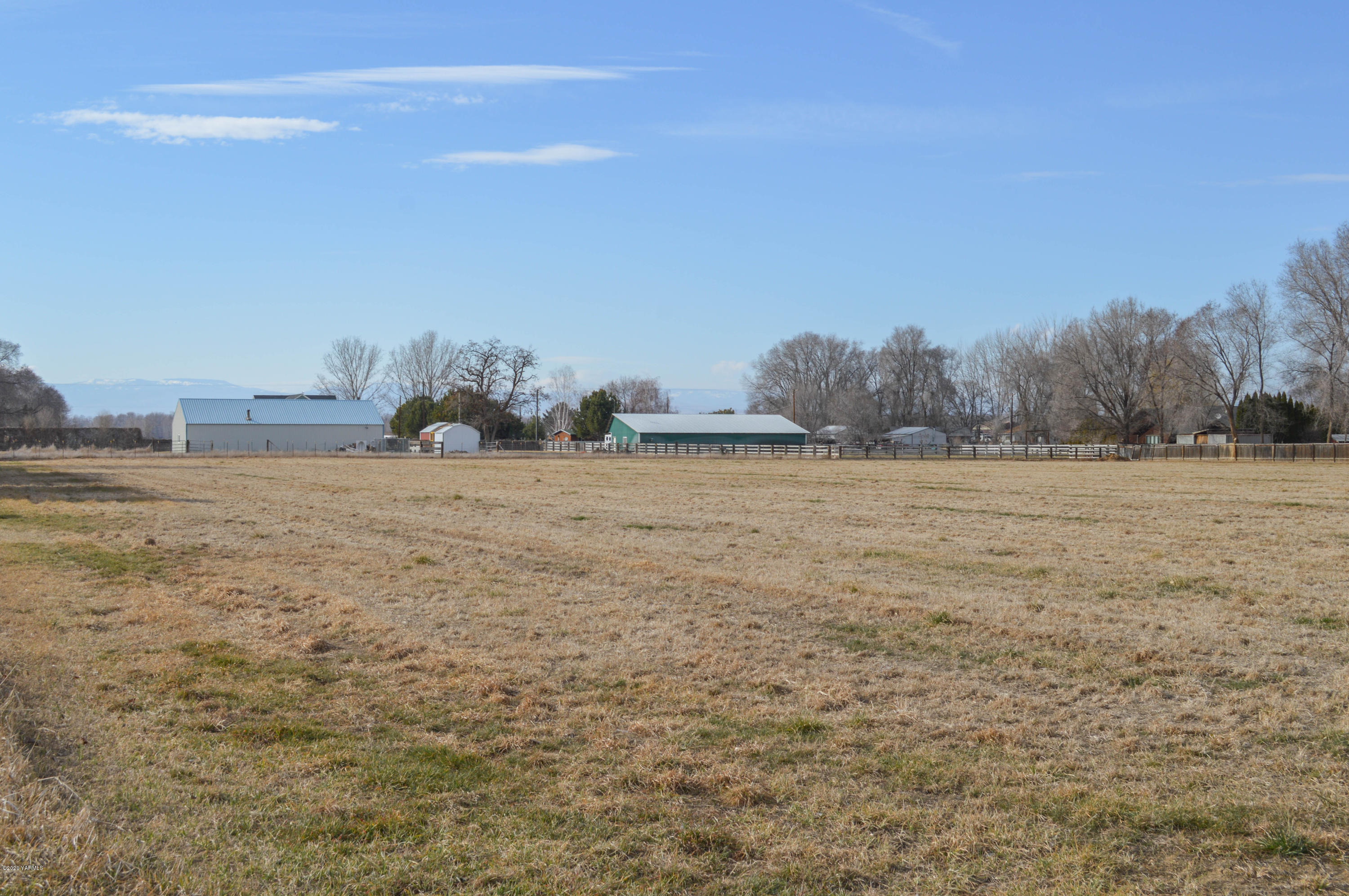 4915 Gamache Road Moxee, WA 98936 - Photo 6 of 6 a view of a field with trees in background