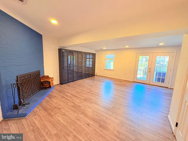 a spacious bedroom with a large bed and a large window