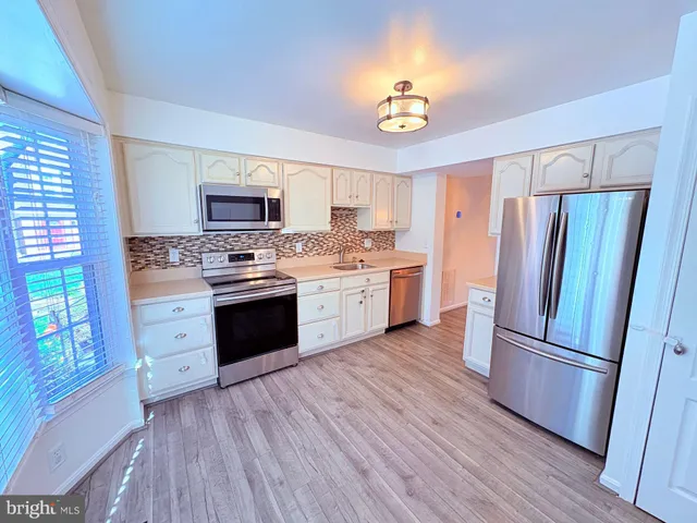 a kitchen with a refrigerator stove and sink