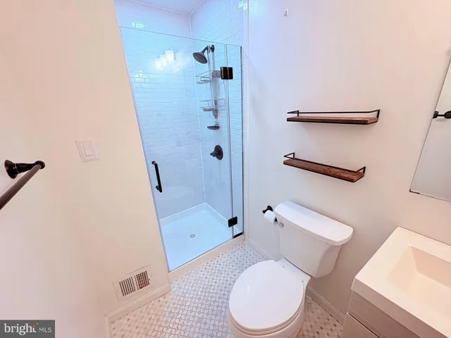 a white toilet sitting next to a bathroom sink