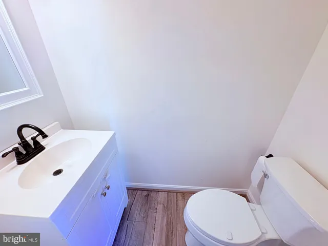 a white toilet sitting next to a bathroom sink
