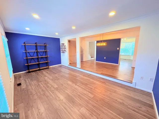 an empty room with wooden floor and closet