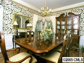 7620 Ridgefield Drive Charlotte, NC 28269 - Photo 3 of 8 a view of a dining room with furniture and chandelier