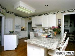7620 Ridgefield Drive Charlotte, NC 28269 - Photo 5 of 8 a kitchen with a sink appliances and cabinets