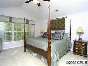 7620 Ridgefield Drive Charlotte, NC 28269 - Photo 7 of 8 a bedroom with a bed window and a lamp