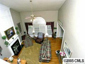7620 Ridgefield Drive Charlotte, NC 28269 - Photo 8 of 8 a living room with furniture a flat screen tv and a fireplace