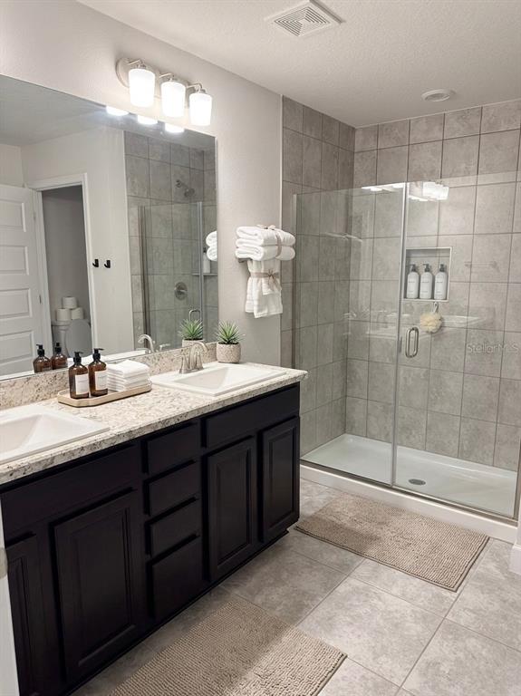13058 Ogden Glade Road Dade City, FL 33525 - Photo 11 of 14 a bathroom with a double vanity sink mirror and shower