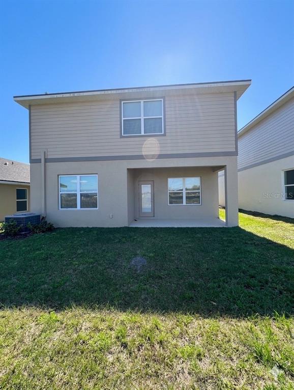 13058 Ogden Glade Road Dade City, FL 33525 - Photo 14 of 14 a view of a house with a yard