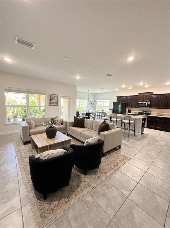 13058 Ogden Glade Road Dade City, FL 33525 - Photo 2 of 14 a living room with furniture and a table