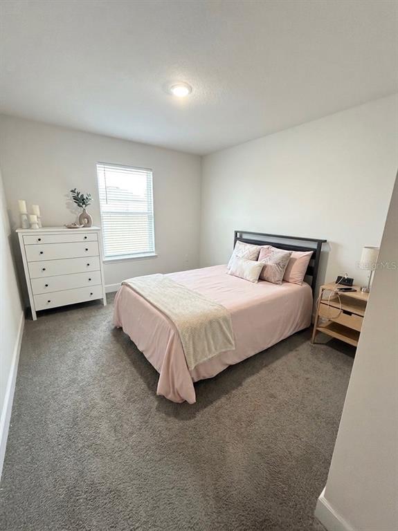 13058 Ogden Glade Road Dade City, FL 33525 - Photo 7 of 14 a bedroom with a bed and a couch