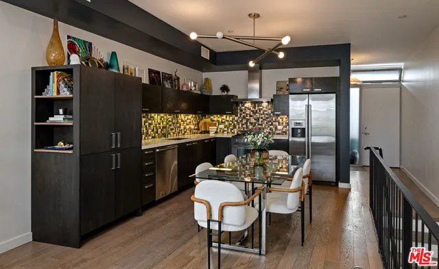 a dining room with furniture and wooden floor