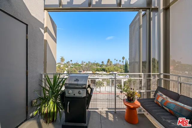 a view of a balcony with chairs and wooden floor