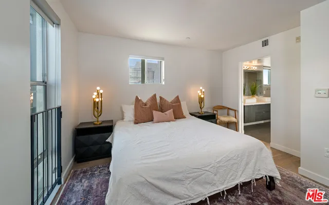 a bedroom with a bed and a lamp on table