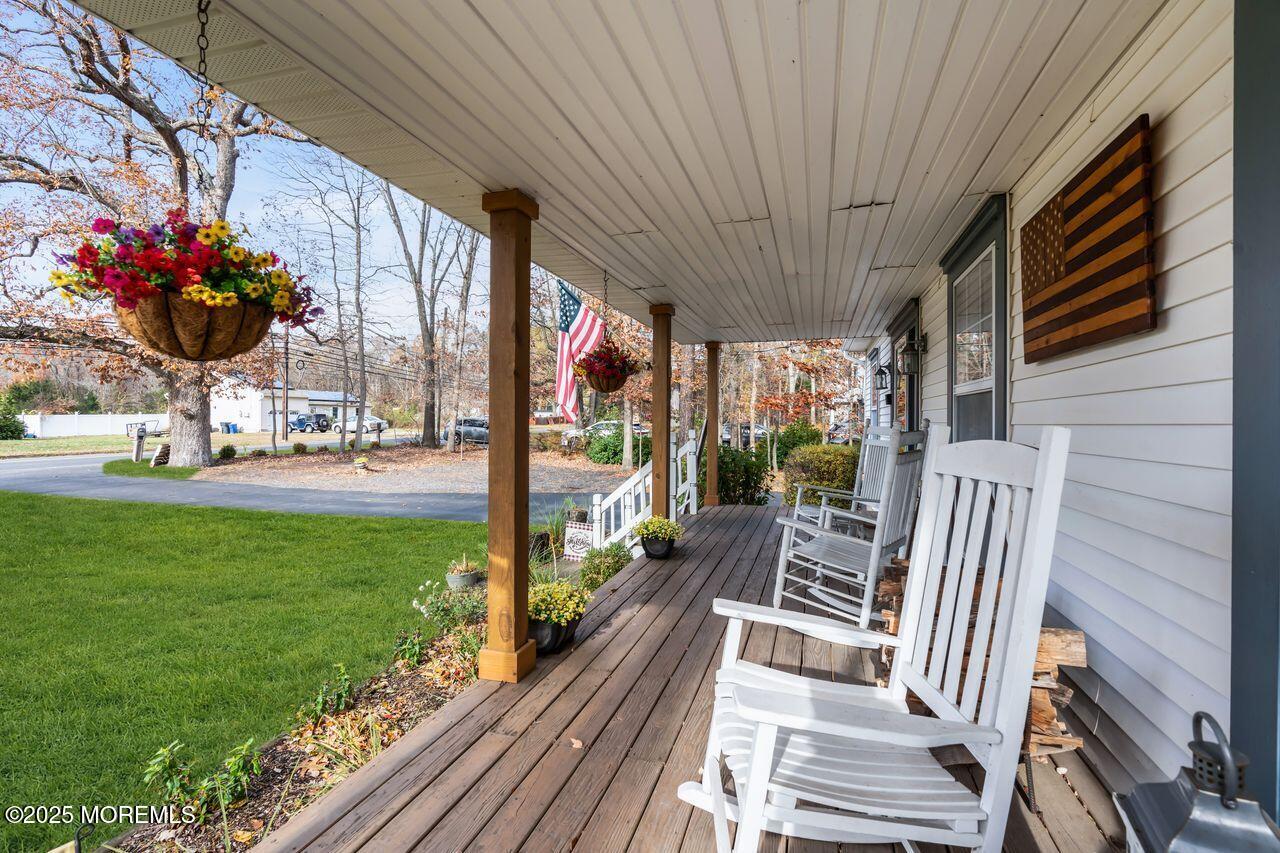 1300 Maxim Southard Road Howell, NJ 07731 - Photo 15 of 61 a view of a patio with a table chairs and a flower garden