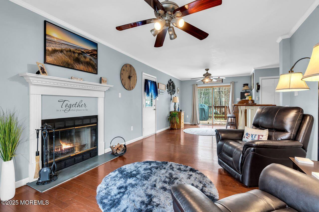 1300 Maxim Southard Road Howell, NJ 07731 - Photo 29 of 61 a living room with furniture a fireplace and a flat screen tv