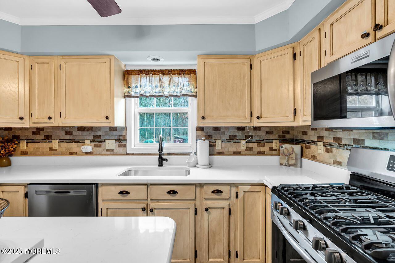 1300 Maxim Southard Road Howell, NJ 07731 - Photo 3 of 61 a kitchen with stainless steel appliances granite countertop a stove a sink dishwasher and a microwave oven with white cabinets