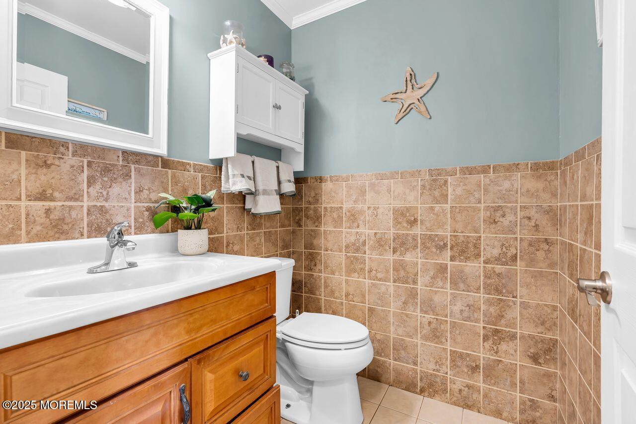 1300 Maxim Southard Road Howell, NJ 07731 - Photo 31 of 61 a bathroom with a sink a toilet and a mirror