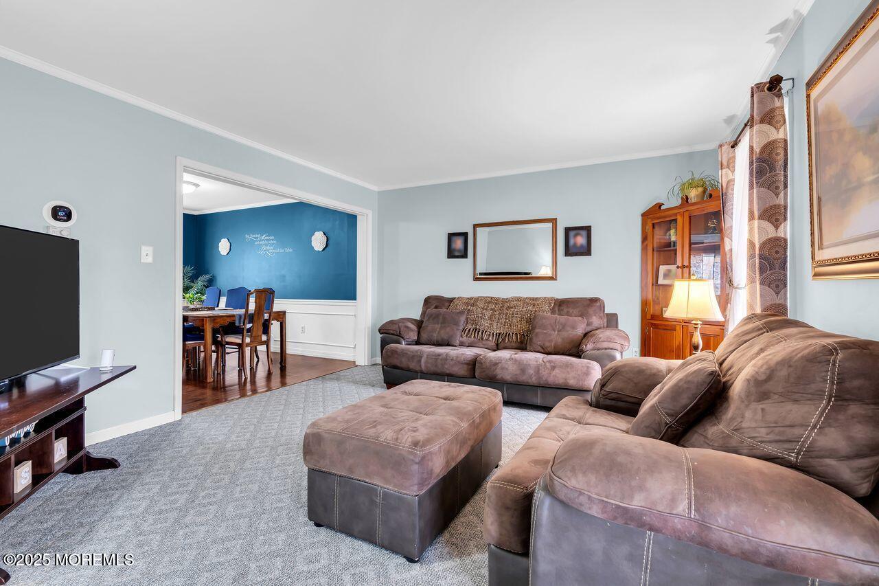 1300 Maxim Southard Road Howell, NJ 07731 - Photo 32 of 61 a living room with furniture and a flat screen tv