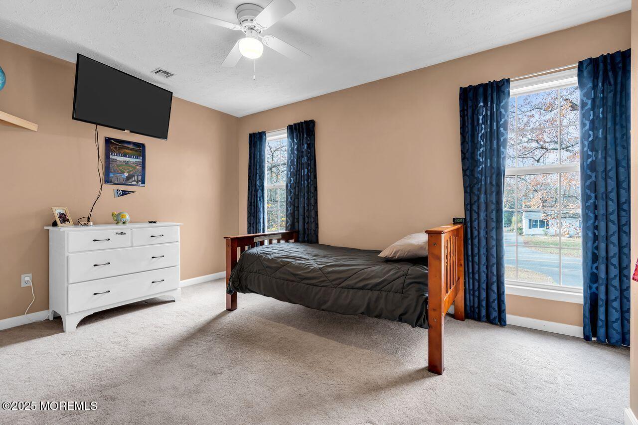 1300 Maxim Southard Road Howell, NJ 07731 - Photo 33 of 61 a living room with furniture and a flat screen tv