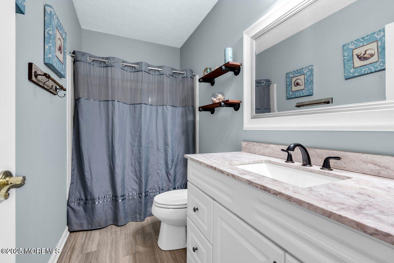 1300 Maxim Southard Road Howell, NJ 07731 - Photo 35 of 61 a bathroom with a granite countertop sink toilet and shower
