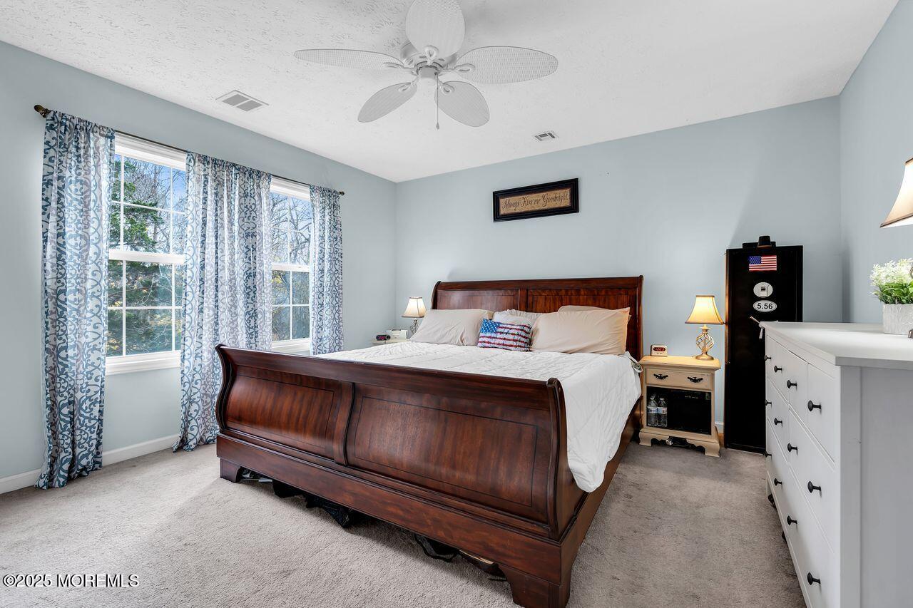 1300 Maxim Southard Road Howell, NJ 07731 - Photo 36 of 61 a spacious bedroom with a bed and a window