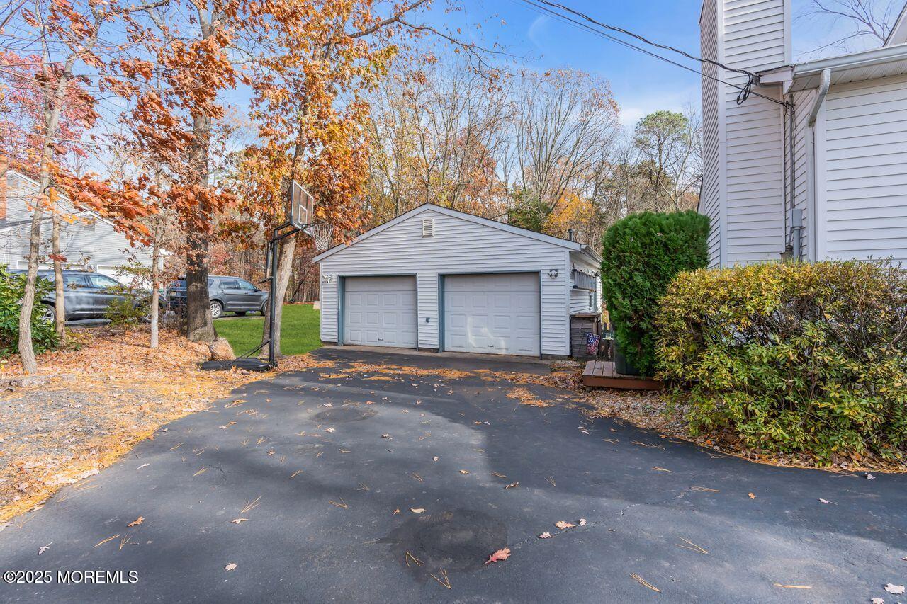 1300 Maxim Southard Road Howell, NJ 07731 - Photo 45 of 61 a front view of a house with a yard and garage