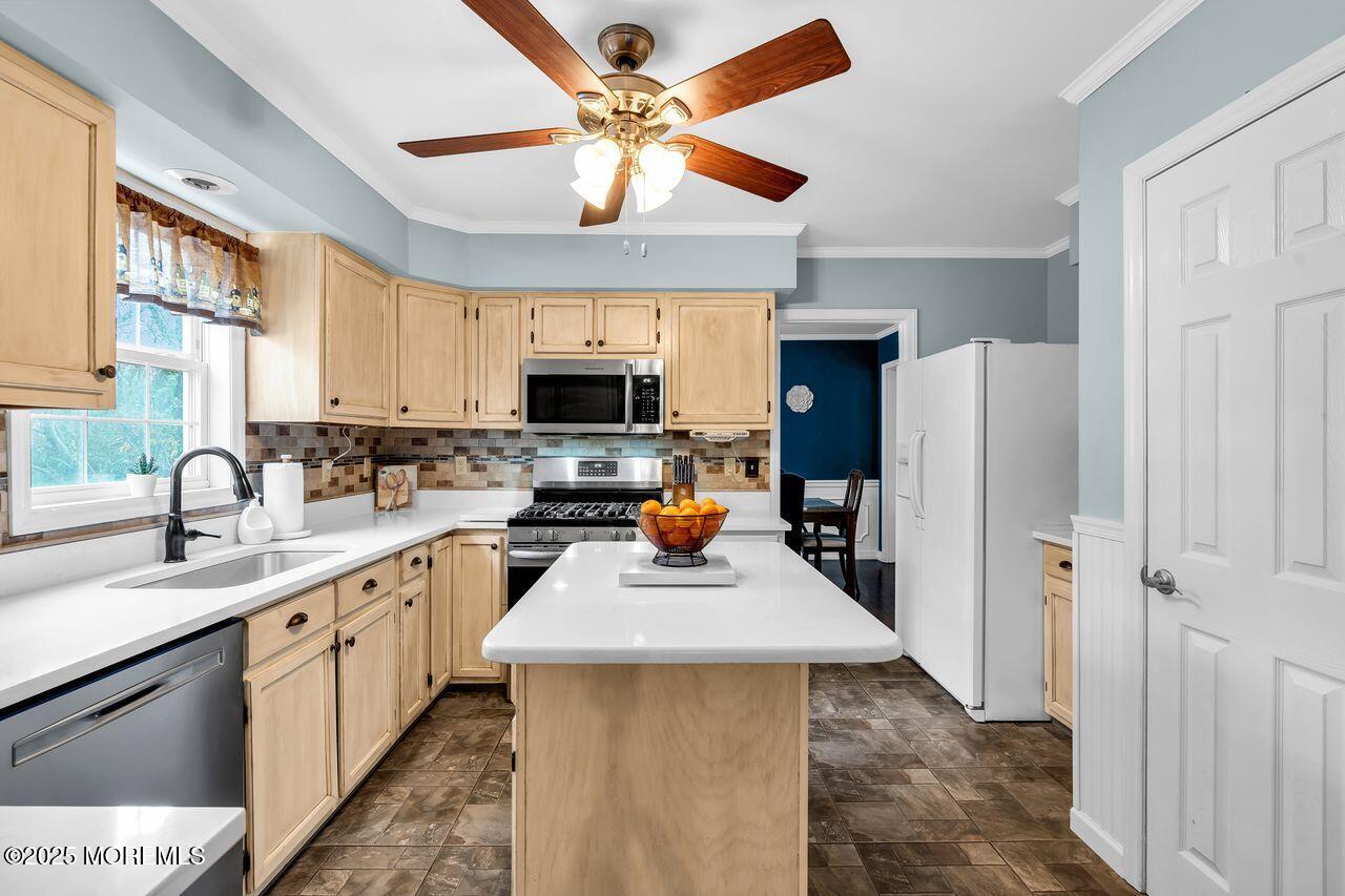 1300 Maxim Southard Road Howell, NJ 07731 - Photo 5 of 61 a kitchen with a refrigerator a sink dishwasher and a stove with wooden floor