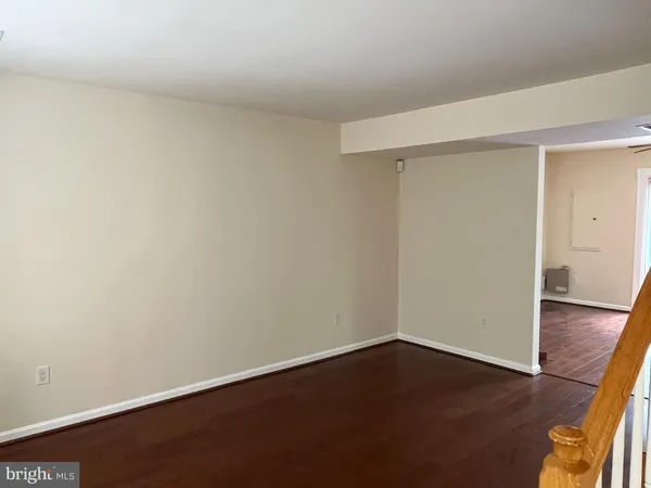 an empty room with wooden floor