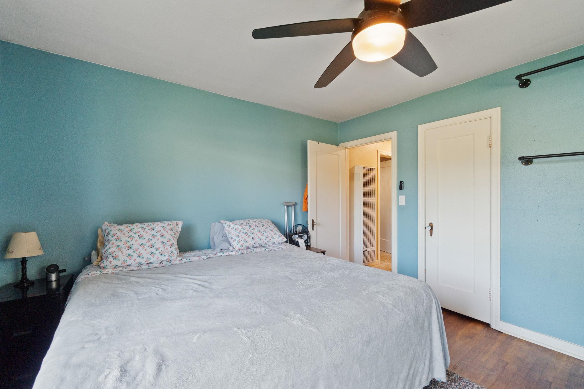 355 Jackson Street Red Bluff, CA 96080 - Photo 10 of 24 a bedroom with a bed and a chandelier