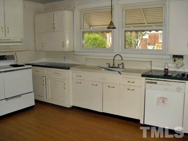 2509 Ross Road Durham, NC 27703 - Photo 16 of 24 a kitchen with white cabinets and a window